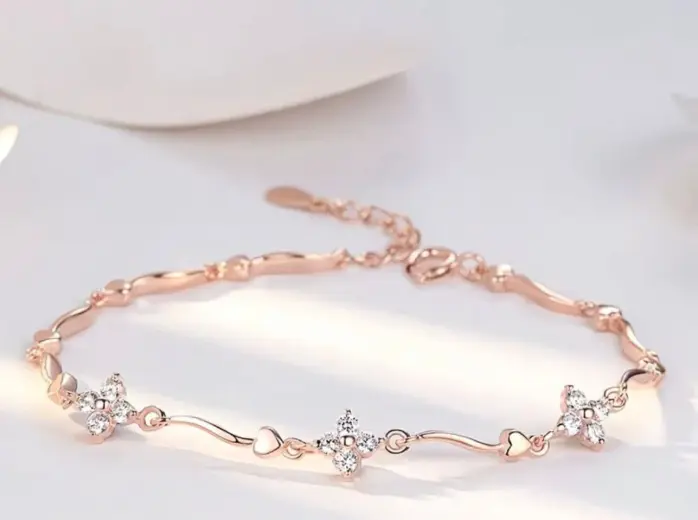 Rose gold four leaf clover station bracelet with heart accent